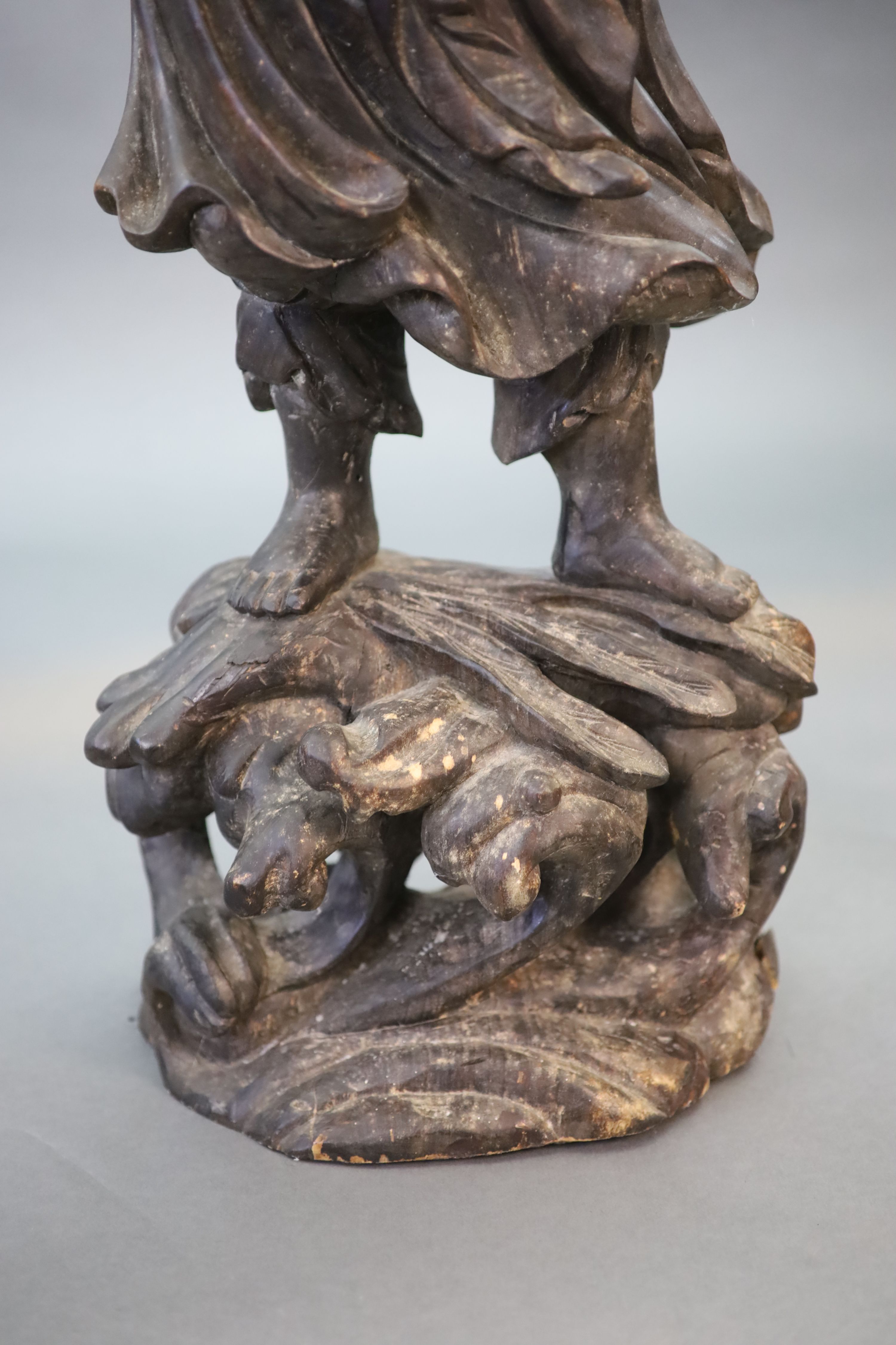 An early 20th Chinese carved hardwood figure of a Luohan